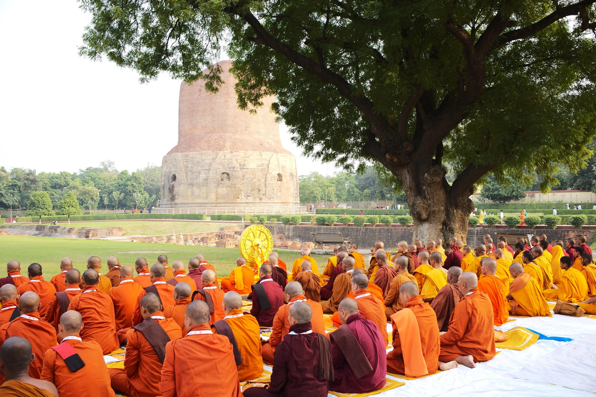 Monks assembled before the Dhamek Stupa in Sarnath, where the Buddha first taught the Four Noble Truths