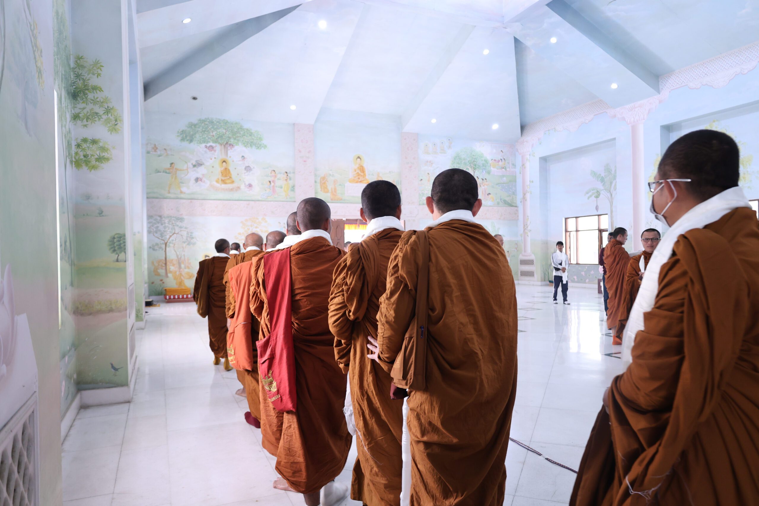 Monastics gathered under the Neem trees for the Dharmachakra Program