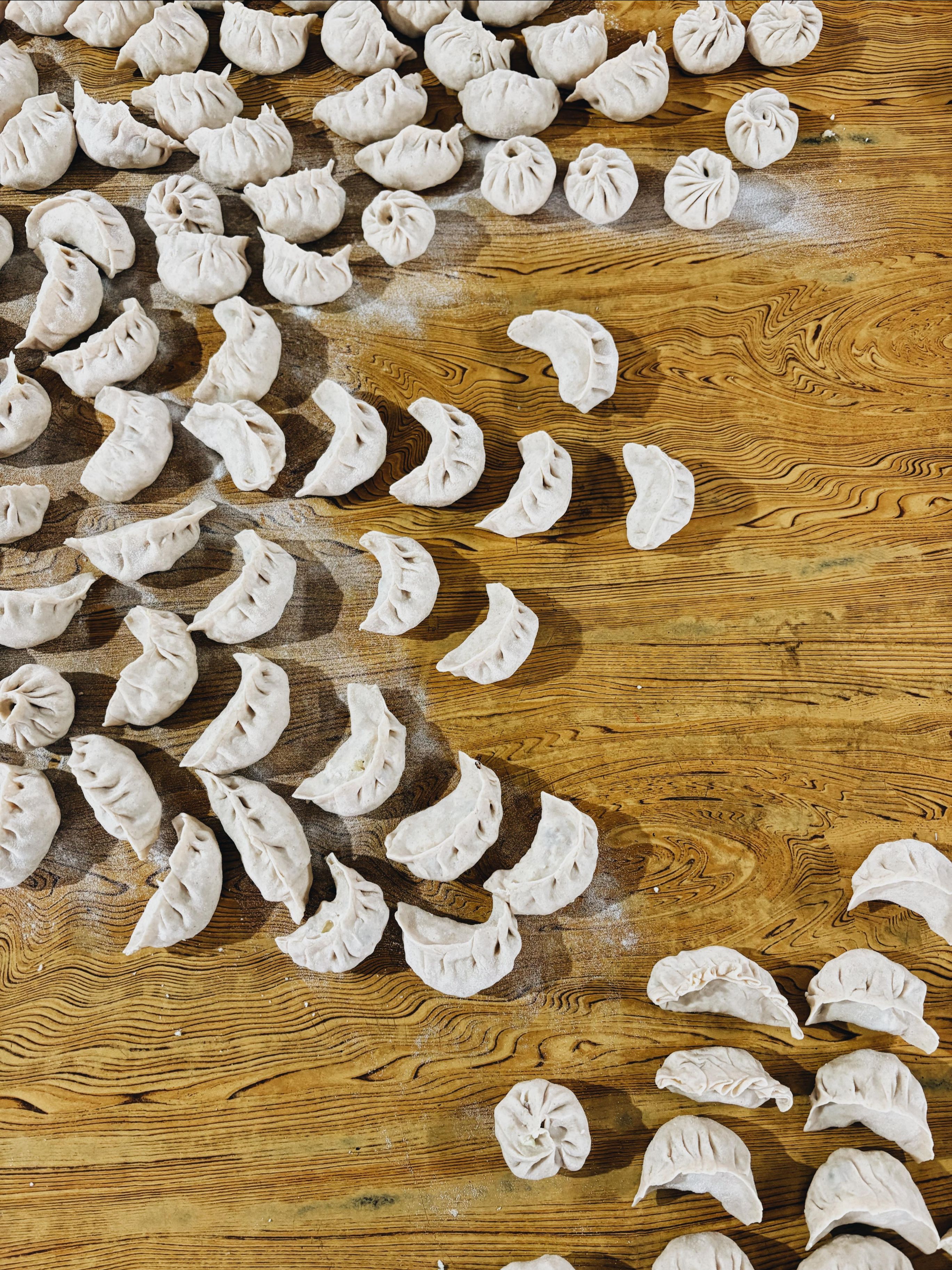 The group enjoying freshly made momos at the end of the summer program